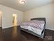 Spacious bedroom with hardwood floors leading to the ensuite bathroom at 7015 Walnut Branch Ln, Charlotte, NC 28277