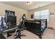 Well-lit bedroom with dark furnishings and gaming setup at 7015 Walnut Branch Ln, Charlotte, NC 28277