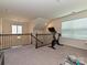 Upper level bonus room showcasing stairway and a fitness bike at 7015 Walnut Branch Ln, Charlotte, NC 28277