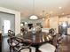 Dining area showcasing designer chairs, hardwood floors and seamless transition to the kitchen and living spaces at 7015 Walnut Branch Ln, Charlotte, NC 28277