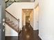Inviting foyer featuring hardwood floors, staircase with wrought iron spindles, and an open layout at 7015 Walnut Branch Ln, Charlotte, NC 28277