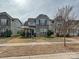 Charming two-story home with stone accents, a covered porch, and manicured landscaping at 7015 Walnut Branch Ln, Charlotte, NC 28277