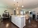 Bright open-concept kitchen with stainless appliances and island that flows into the dining and living area at 7015 Walnut Branch Ln, Charlotte, NC 28277