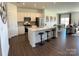 Modern kitchen with white cabinets, stainless steel appliances, and a large center island with barstool seating at 705 Hallman Branch Ln, Lincolnton, NC 28092