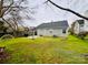Wide backyard featuring an installed basketball hoop and manicured lawn at 7204 Cranswick Pl, Charlotte, NC 28227