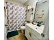Cozy bathroom with modern vanity, decorative shower curtain, and framed mirror at 7204 Cranswick Pl, Charlotte, NC 28227