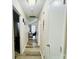 Hallway with wood-look flooring, leading to a room with a desk and window at 7204 Cranswick Pl, Charlotte, NC 28227
