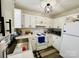 Bright kitchen features white cabinets, tile backsplash, updated appliances, and modern black hardware at 7204 Cranswick Pl, Charlotte, NC 28227
