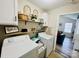 Efficient laundry area with floating shelves and washer and dryer hookups at 7204 Cranswick Pl, Charlotte, NC 28227