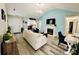 Cozy living room featuring a fireplace, hardwood floors, and an open floor plan at 7204 Cranswick Pl, Charlotte, NC 28227