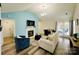 Bright living room with vaulted ceilings, fireplace, and cozy seating arrangement at 7204 Cranswick Pl, Charlotte, NC 28227