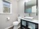 Well-lit bathroom featuring modern sink, vanity with storage, and tiled floor at 7435 Trotter Rd, Charlotte, NC 28216