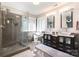 Modern bathroom featuring dual vanities, a glass-enclosed shower, and contemporary finishes at 7435 Trotter Rd, Charlotte, NC 28216
