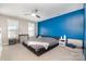Spacious bedroom with a blue accent wall, ceiling fan, and comfortable seating area at 7435 Trotter Rd, Charlotte, NC 28216