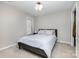 Comfortable bedroom with neutral tones, a cozy bed, and natural light from the window at 7435 Trotter Rd, Charlotte, NC 28216