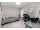 Functional bedroom with a bed, desk, and shelving for organization and productivity at 7435 Trotter Rd, Charlotte, NC 28216