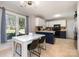 Bright dining area features a white table set with black chairs and a window with backyard views at 7435 Trotter Rd, Charlotte, NC 28216