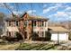Charming two-story home featuring a brick facade, neutral siding, and a well-manicured front yard at 7435 Trotter Rd, Charlotte, NC 28216