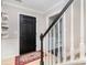 Inviting foyer with tile flooring, staircase, and decorative rug, creating a warm and welcoming entrance at 7435 Trotter Rd, Charlotte, NC 28216