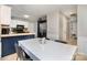Well-lit kitchen with a breakfast bar, stainless steel appliances, and neutral-toned walls and floors at 7435 Trotter Rd, Charlotte, NC 28216