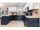 Updated kitchen features stainless appliances, dark cabinetry, and modern countertops at 7435 Trotter Rd, Charlotte, NC 28216