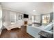 Comfortable living room featuring a fireplace with decorative cabinets, hardwood floors, and ample seating at 7435 Trotter Rd, Charlotte, NC 28216