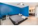 Bright main bedroom with a vibrant blue wall that leads into a bathroom with modern vanities at 7435 Trotter Rd, Charlotte, NC 28216
