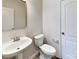 Modern powder room featuring white fixtures and neutral wall paint at 8055 Hereford St, Charlotte, NC 28213