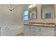 Bright bathroom featuring a tub, shower, vanity, and classic chandelier at 8055 Hereford St, Charlotte, NC 28213
