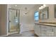 Bright bathroom featuring a tub, shower, vanity, and classic chandelier at 8055 Hereford St, Charlotte, NC 28213