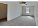 Bedroom features neutral carpet, walls, and natural light from the window at 8055 Hereford St, Charlotte, NC 28213