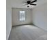 This bedroom features neutral walls, a ceiling fan, and a window allowing ample natural light at 8055 Hereford St, Charlotte, NC 28213