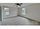 Spacious bedroom features neutral carpet, walls, and natural light from the double windows at 8055 Hereford St, Charlotte, NC 28213