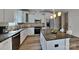 Bright kitchen with white cabinets, stainless steel appliances and center island with granite countertop at 8055 Hereford St, Charlotte, NC 28213