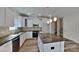 Bright kitchen with white cabinets, stainless steel appliances and center island with granite countertop at 8055 Hereford St, Charlotte, NC 28213