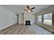 Bright living room with a fireplace, sleek flooring, and abundant natural light from large windows at 8055 Hereford St, Charlotte, NC 28213