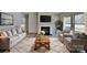 Cozy living room featuring a fireplace, neutral tones, large windows, and comfortable seating at 8055 Hereford St, Charlotte, NC 28213