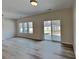 Spacious living area with sleek flooring, backyard access, and bright neutral walls at 8055 Hereford St, Charlotte, NC 28213