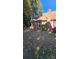 Home exterior featuring brick, windows, and a cozy backyard with mature trees at 8731 Sheltonham Way, Charlotte, NC 28216