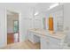Bright bathroom featuring a double sink vanity, large mirror, and tile flooring at 8731 Sheltonham Way, Charlotte, NC 28216