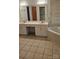 Spacious bathroom featuring a double vanity, soaking tub and tiled flooring at 8731 Sheltonham Way, Charlotte, NC 28216