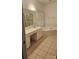 Bathroom with large vanity and soaking tub, tiled floors and a separate shower at 8731 Sheltonham Way, Charlotte, NC 28216