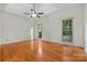 Spacious bedroom featuring hardwood floors and tray ceiling with fan at 8731 Sheltonham Way, Charlotte, NC 28216