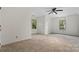 Bright bedroom with white walls and carpeted floors, flooded with natural light at 8731 Sheltonham Way, Charlotte, NC 28216