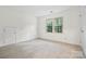 Bright bedroom featuring carpeted floors and a window with wooded views at 8731 Sheltonham Way, Charlotte, NC 28216