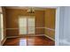 Dining room featuring hardwood floors, stylish plantation shutters and classic chandelier at 8731 Sheltonham Way, Charlotte, NC 28216