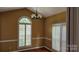 Bright dining room with hardwood floors, chandelier, and plantation shutters at 8731 Sheltonham Way, Charlotte, NC 28216