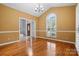Dining room with hardwood floors and sunny window with shutter blinds at 8731 Sheltonham Way, Charlotte, NC 28216
