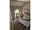 Bright foyer with hardwood floors, arched window, chandelier, and staircase at 8731 Sheltonham Way, Charlotte, NC 28216