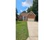 Charming brick home with a well-maintained front lawn and attached two car garage at 8731 Sheltonham Way, Charlotte, NC 28216